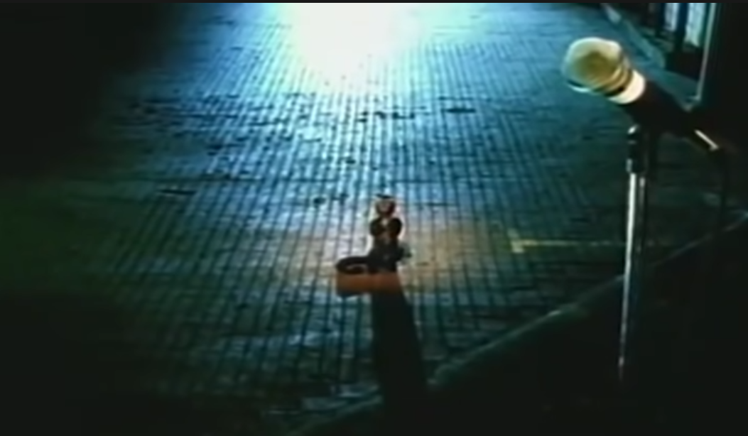 A picture of a single monkey clapping in an empty concert hall.